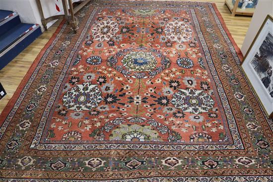 A red ground Persian carpet 352cm x 259cm